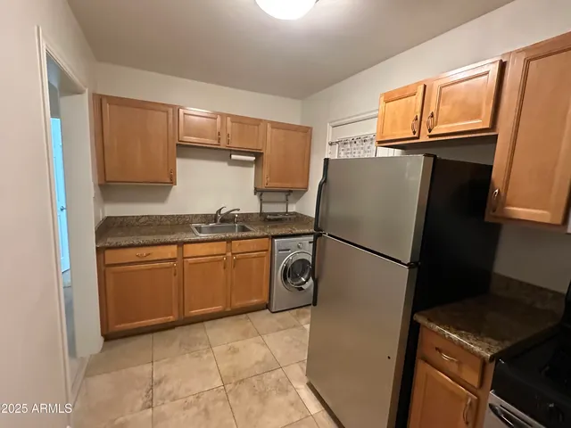 a kitchen with a refrigerator and a stove