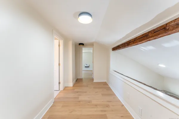 a view of a hallway with wooden floor
