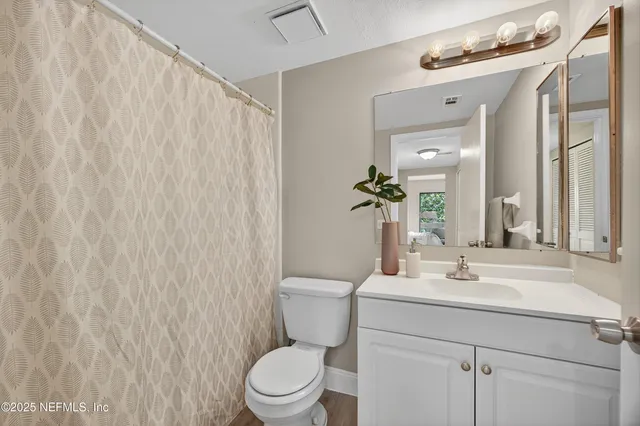 a bathroom with a toilet a sink and a mirror