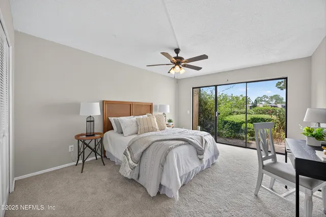 a large bed sitting in a bedroom next to a window