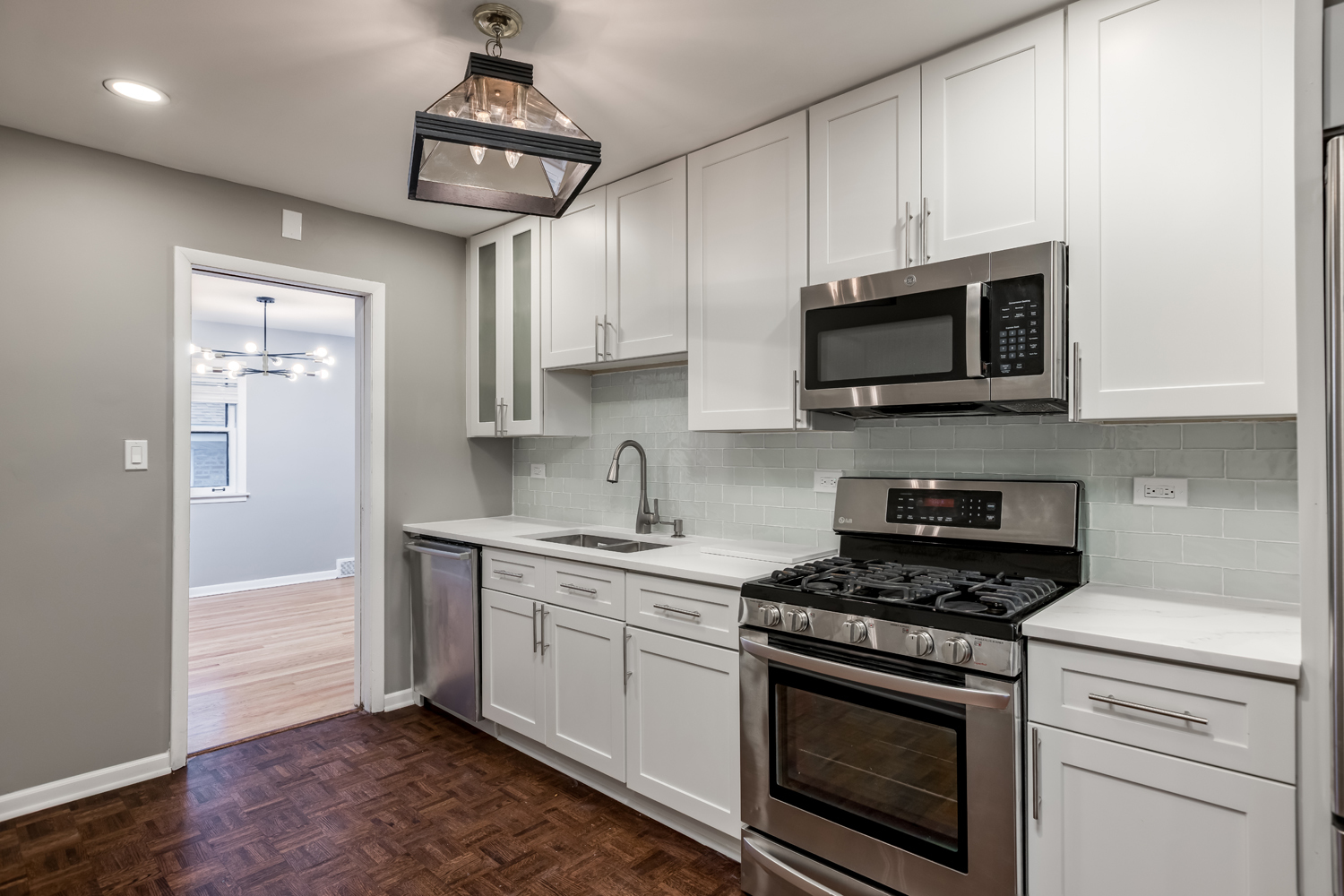 9539 Lorel Avenue Skokie, IL 60077 - Photo 11 of 38 a kitchen with stainless steel appliances granite countertop a stove a microwave and cabinets