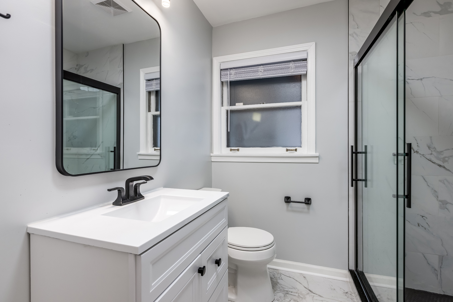 9539 Lorel Avenue Skokie, IL 60077 - Photo 16 of 38 a bathroom with a sink a toilet and a mirror