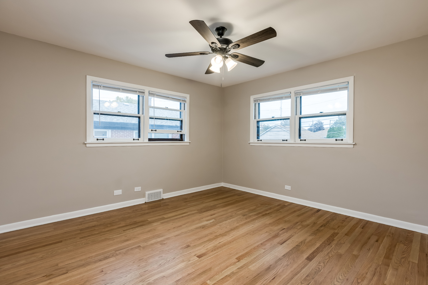 9539 Lorel Avenue Skokie, IL 60077 - Photo 20 of 38 a view of an empty room with wooden floor and a window