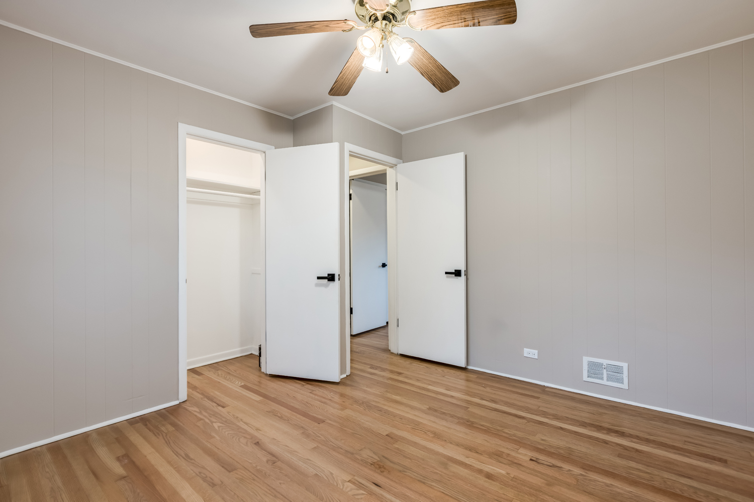 9539 Lorel Avenue Skokie, IL 60077 - Photo 23 of 38 an empty room with wooden floor and ceiling fan