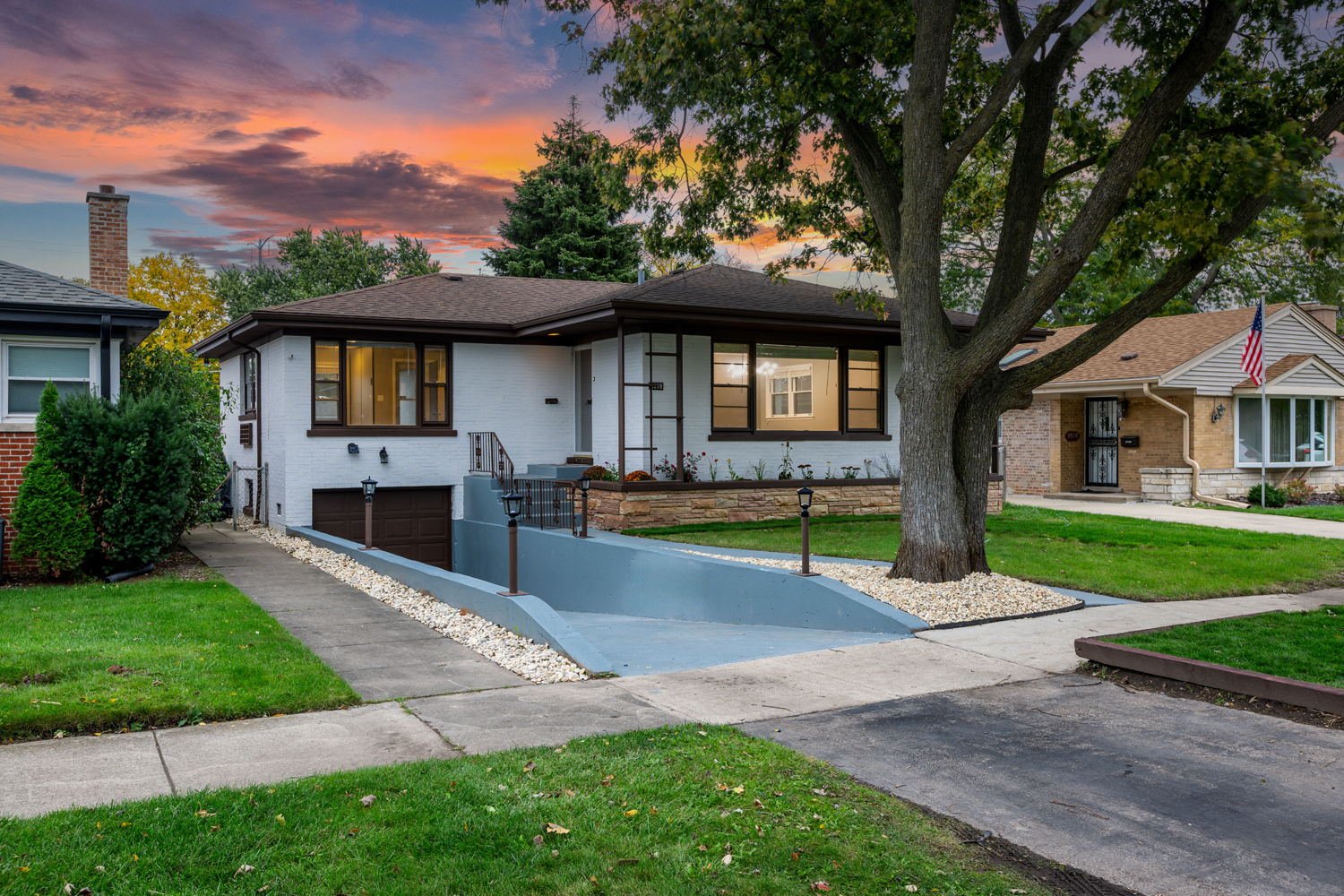 9539 Lorel Avenue Skokie, IL 60077 - Photo 3 of 38 a front view of a house with a yard and garage