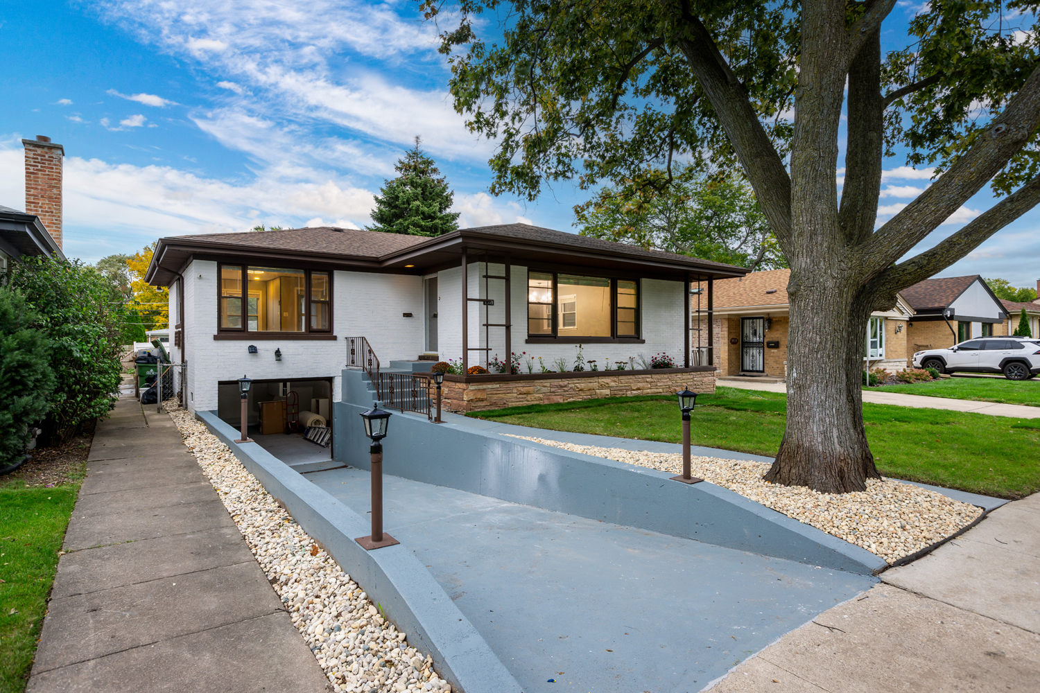 9539 Lorel Avenue Skokie, IL 60077 - Photo 38 of 38 a front view of a house with a yard and garage