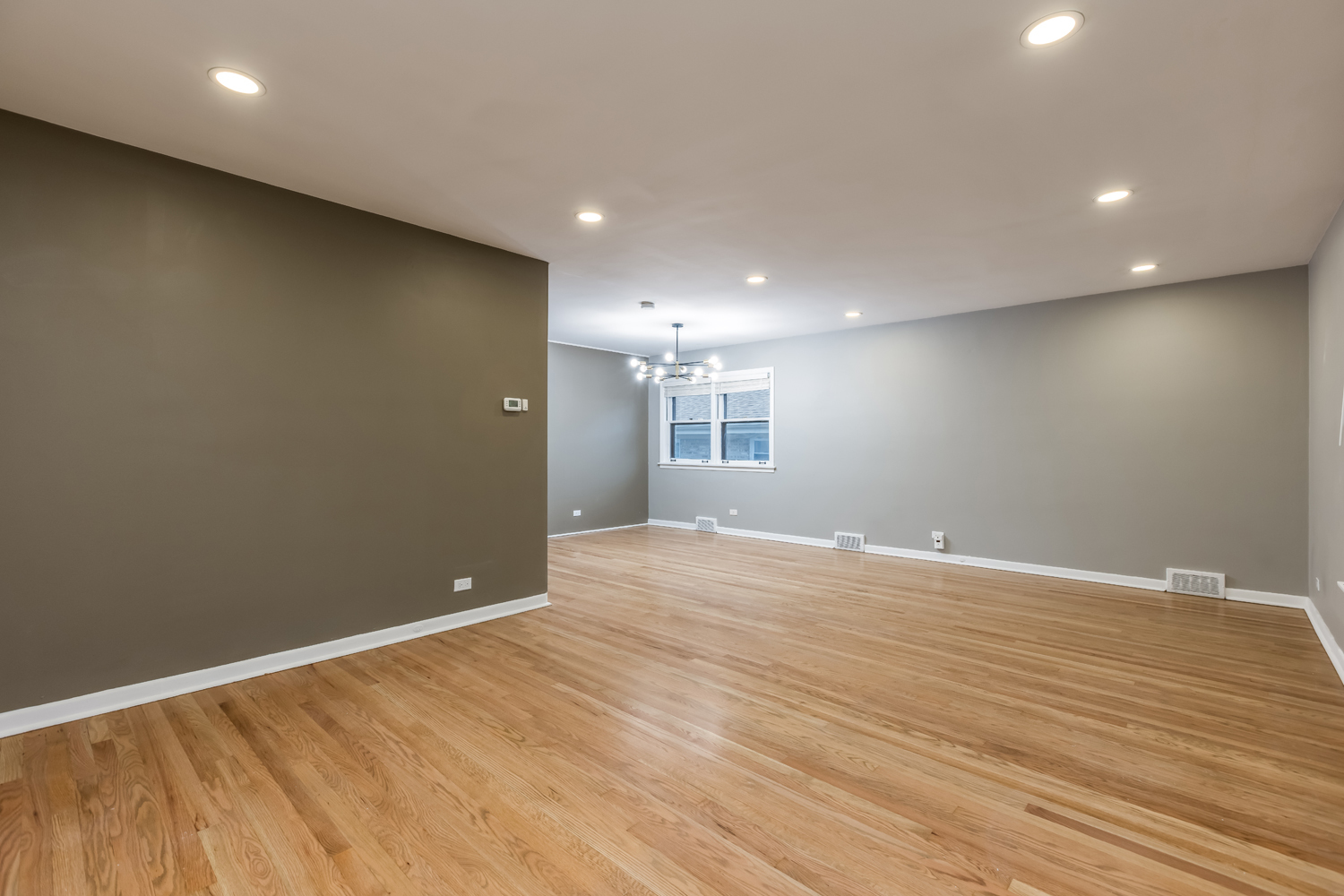 9539 Lorel Avenue Skokie, IL 60077 - Photo 4 of 38 an empty room with wooden floor and windows