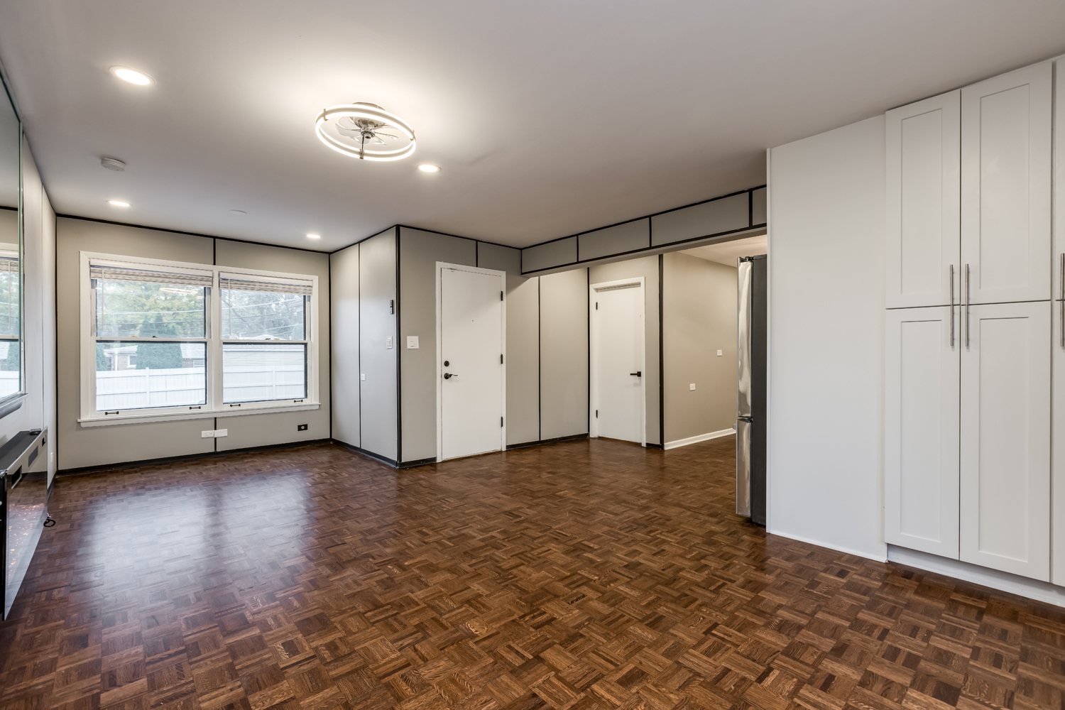 9539 Lorel Avenue Skokie, IL 60077 - Photo 9 of 38 a view of empty room with wooden floor and fan