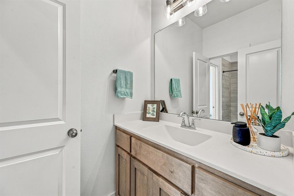 7112 Branch Road Fort Worth, TX 76179 - Photo 29 of 39 Single wood finished vanity attached to second upstairs bedroom.