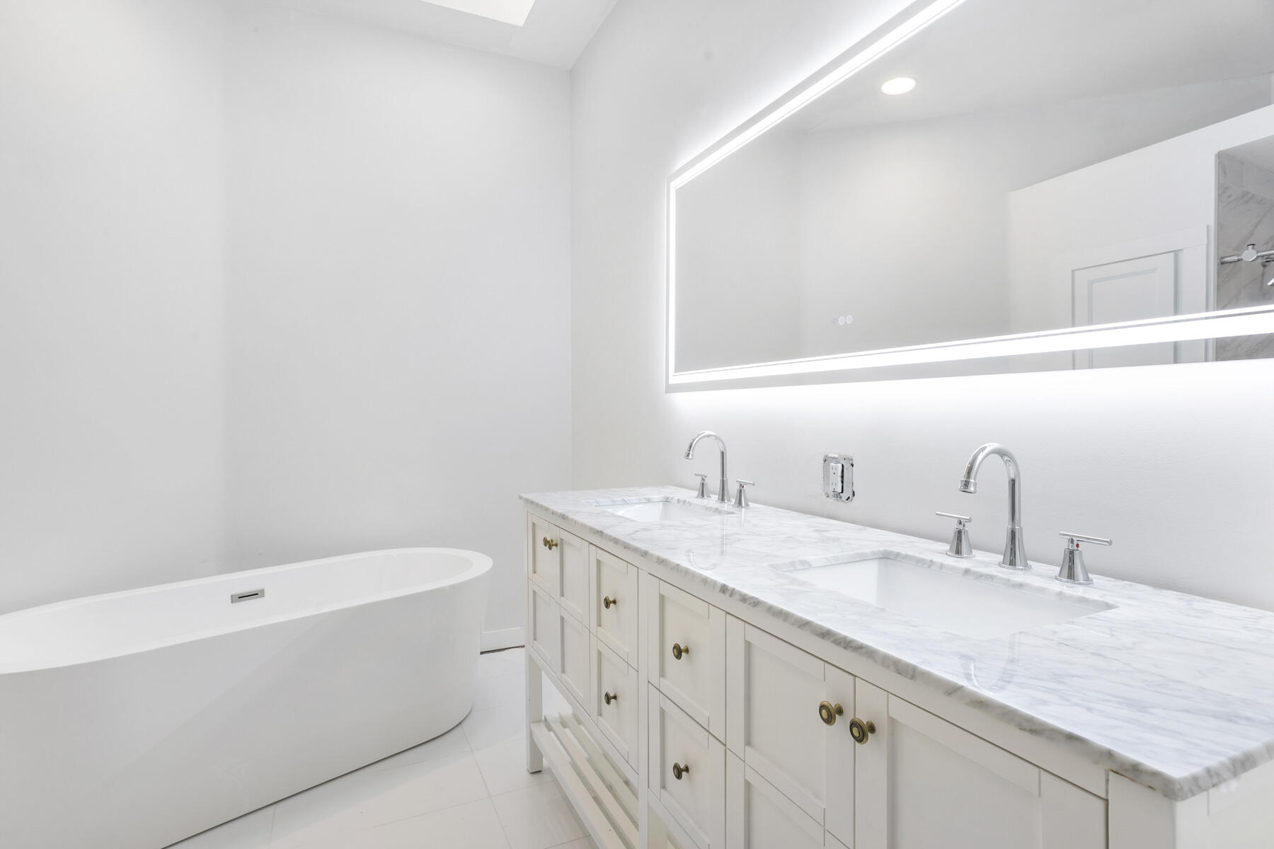 5226 Southeast Inkwood Way Hobe Sound, FL 33455 - Photo 15 of 30 a bathroom with a granite countertop bathtub sink vanity and mirror