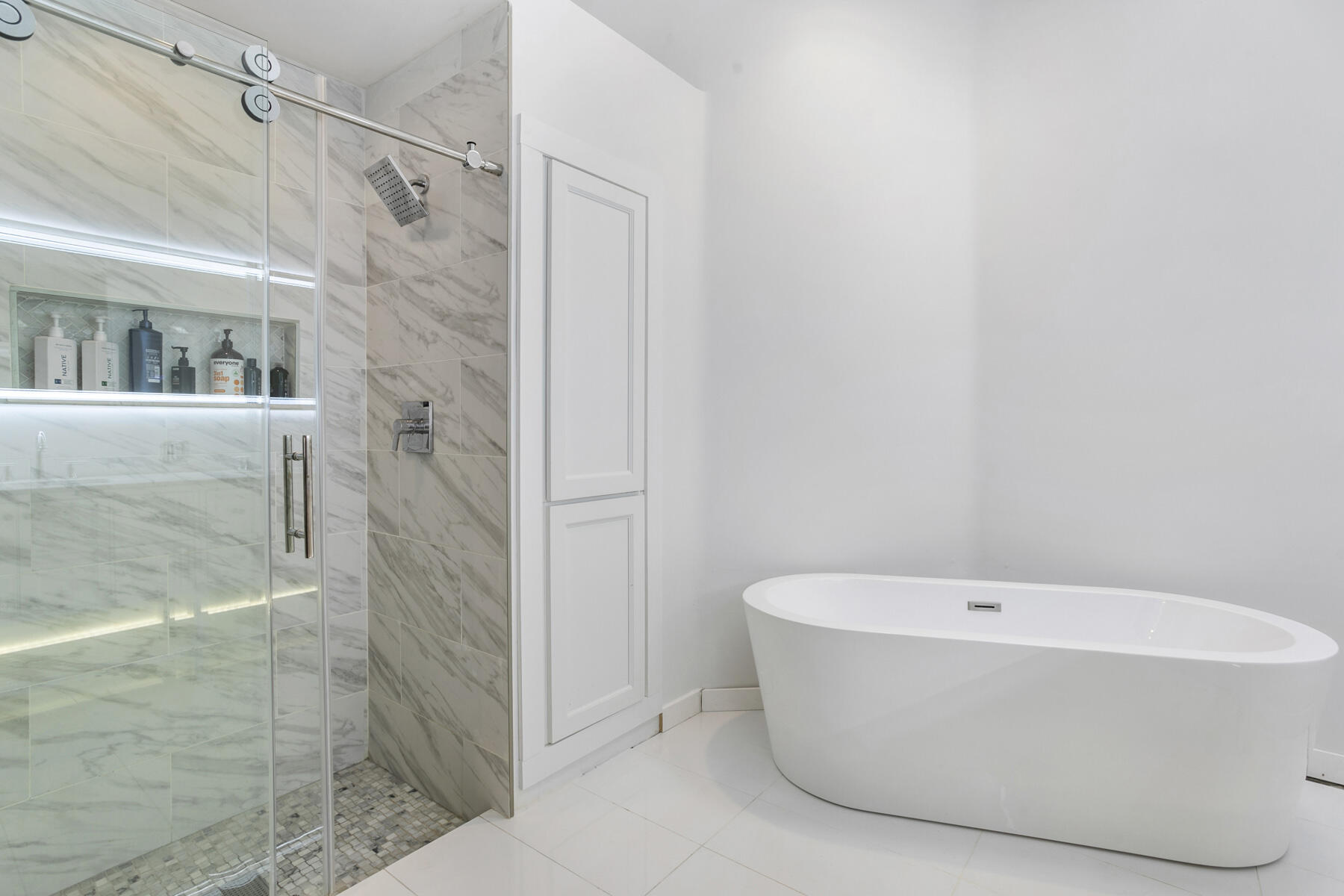 5226 Southeast Inkwood Way Hobe Sound, FL 33455 - Photo 16 of 30 a white bath tub sitting in a bathroom