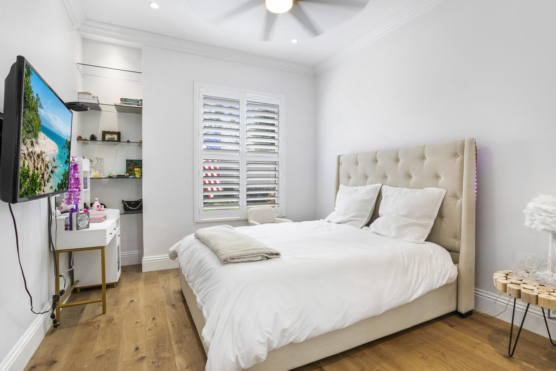 5226 Southeast Inkwood Way Hobe Sound, FL 33455 - Photo 18 of 30 a bedroom with a bed a flat screen tv and a chandelier