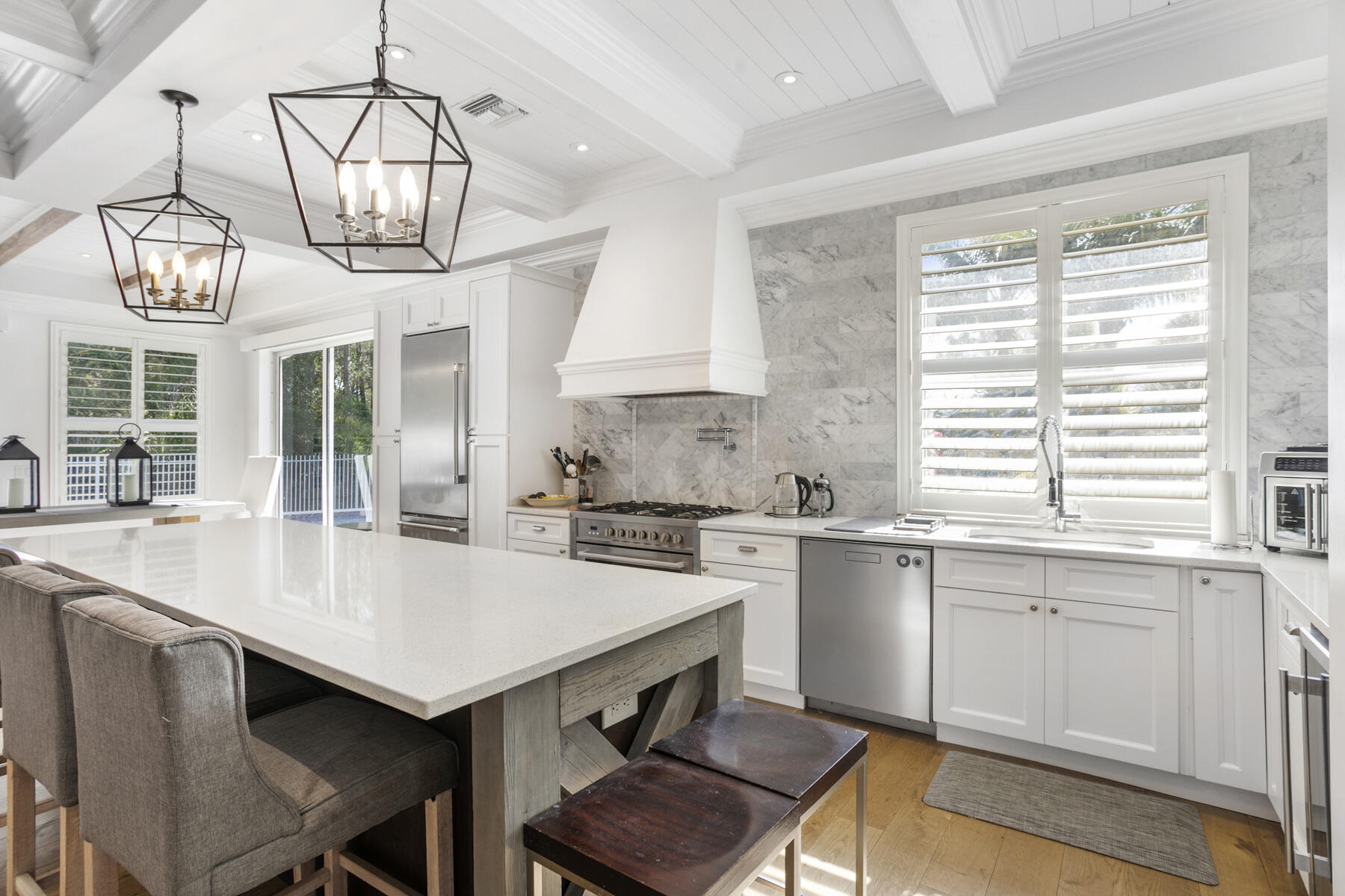 5226 Southeast Inkwood Way Hobe Sound, FL 33455 - Photo 4 of 30 a kitchen with a dining table chairs sink and stove