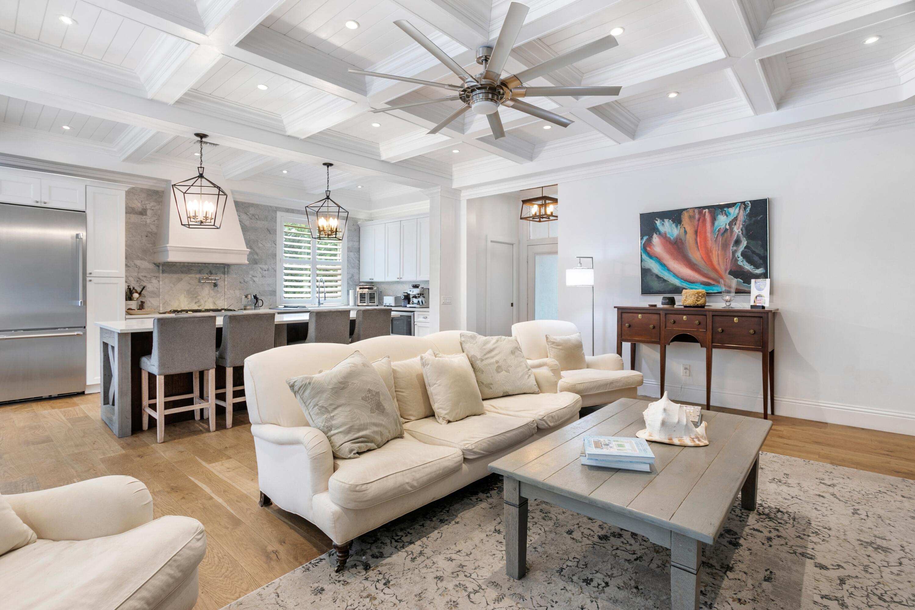 5226 Southeast Inkwood Way Hobe Sound, FL 33455 - Photo 9 of 30 a living room with furniture kitchen view and a chandelier