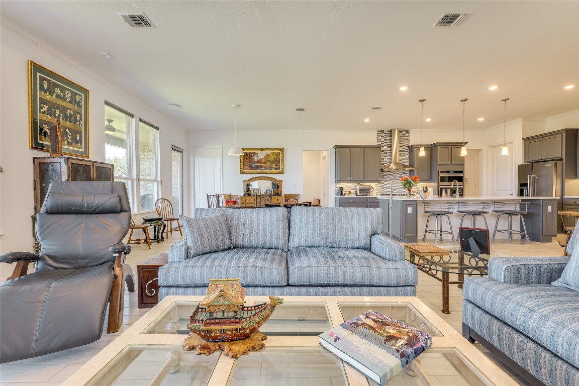 616 Climbing Rock Loop Dripping Springs, TX 78620 - Photo 11 of 35 Living room featuring recessed lighting, ornamental molding, and light wood-style flooring