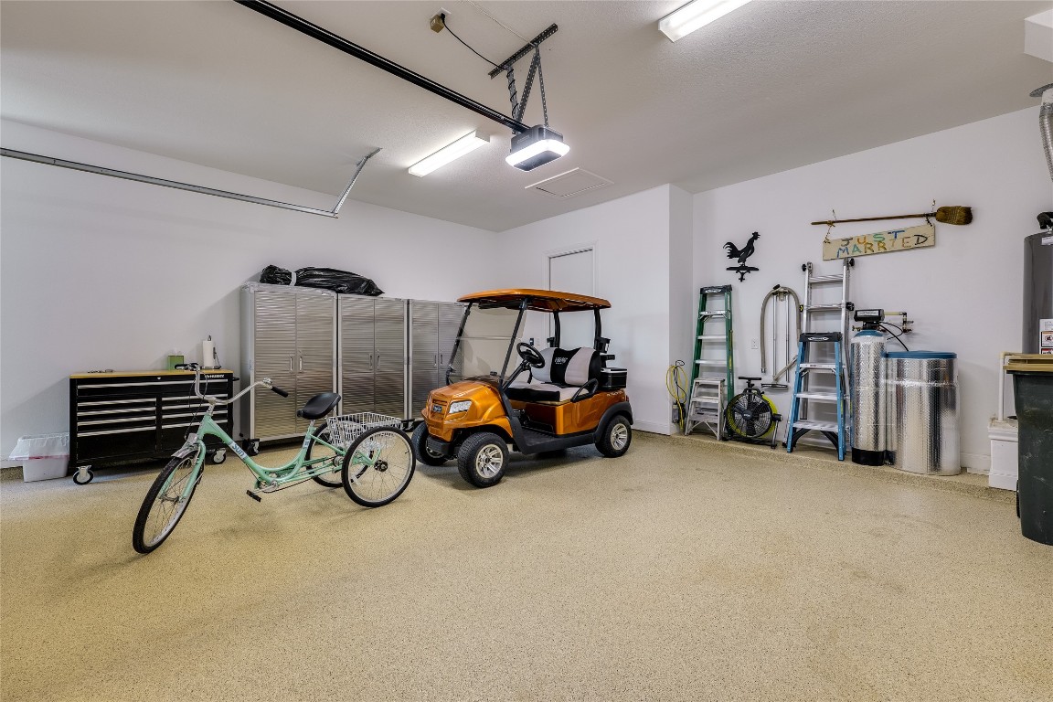 616 Climbing Rock Loop Dripping Springs, TX 78620 - Photo 20 of 35 Garage with a garage door opener and baseboards