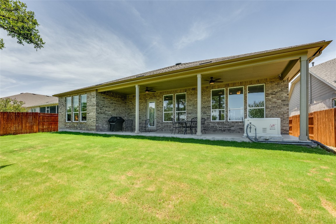 616 Climbing Rock Loop Dripping Springs, TX 78620 - Photo 25 of 35 Rear view of property featuring brick siding, ceiling fan, and a patio
