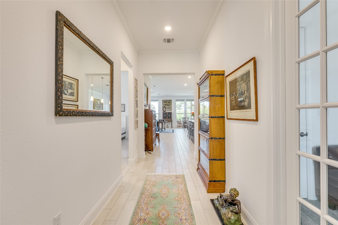 616 Climbing Rock Loop Dripping Springs, TX 78620 - Photo 3 of 35 Corridor featuring recessed lighting, light wood-style flooring, and crown molding