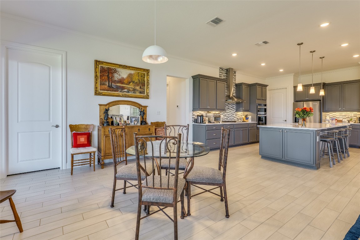 616 Climbing Rock Loop Dripping Springs, TX 78620 - Photo 8 of 35 Dining room featuring wood finish floors, crown molding, and recessed lighting