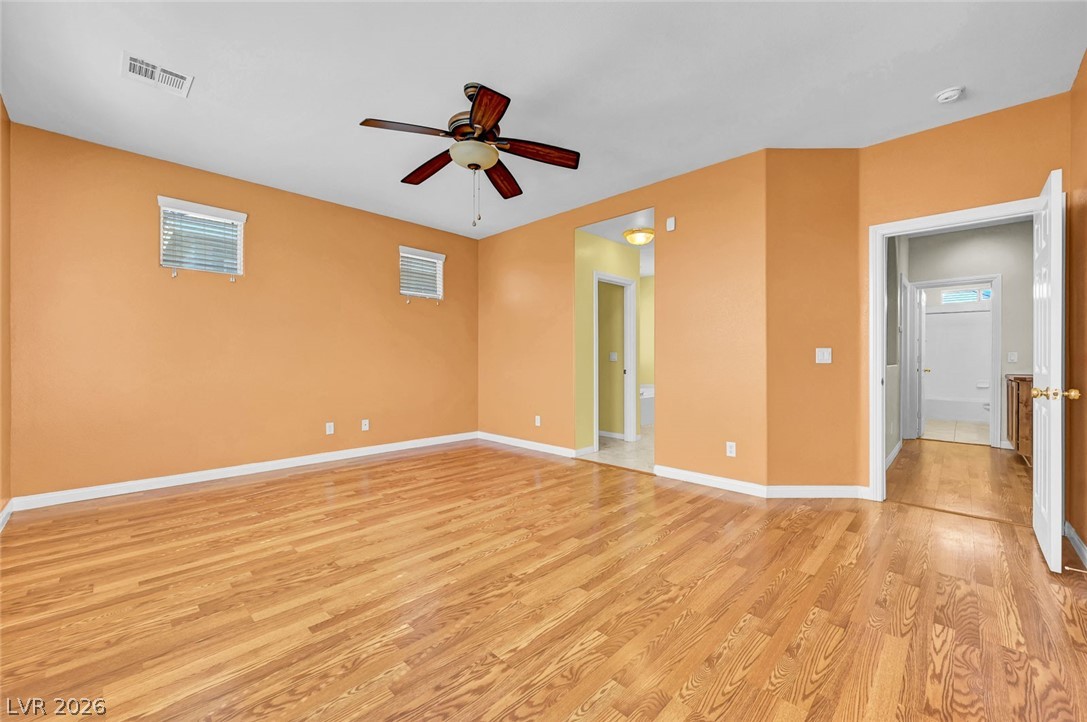 977 Sparkling Light Street Henderson, NV 89052 - Photo 43 of 75 This spacious room features rich wood flooring and a refreshing ceiling fan, perfect for any layout.