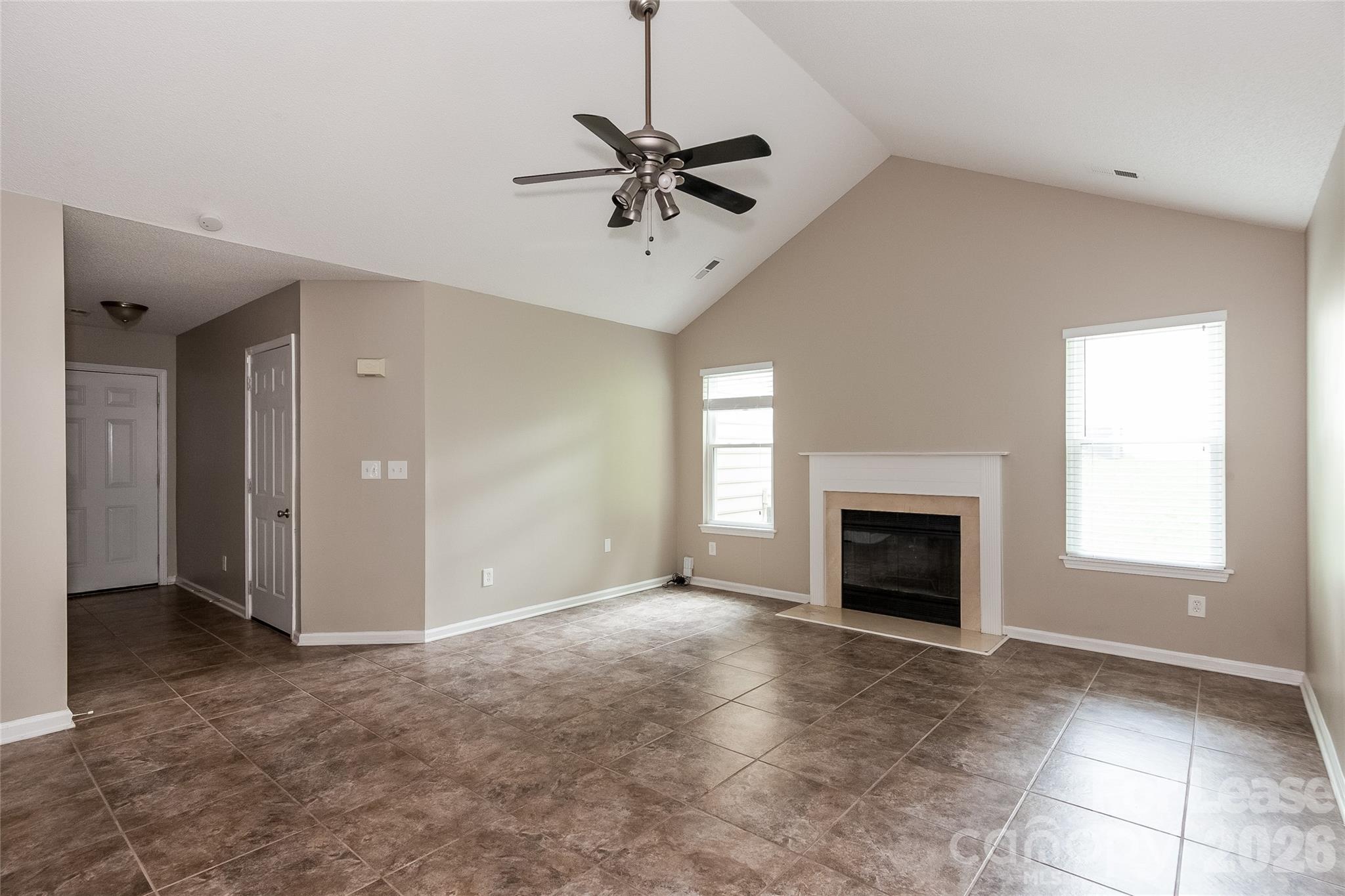 8625 Flowers Court Charlotte, NC 28215 - Photo 3 of 16 a view of an empty room with a fireplace and a window