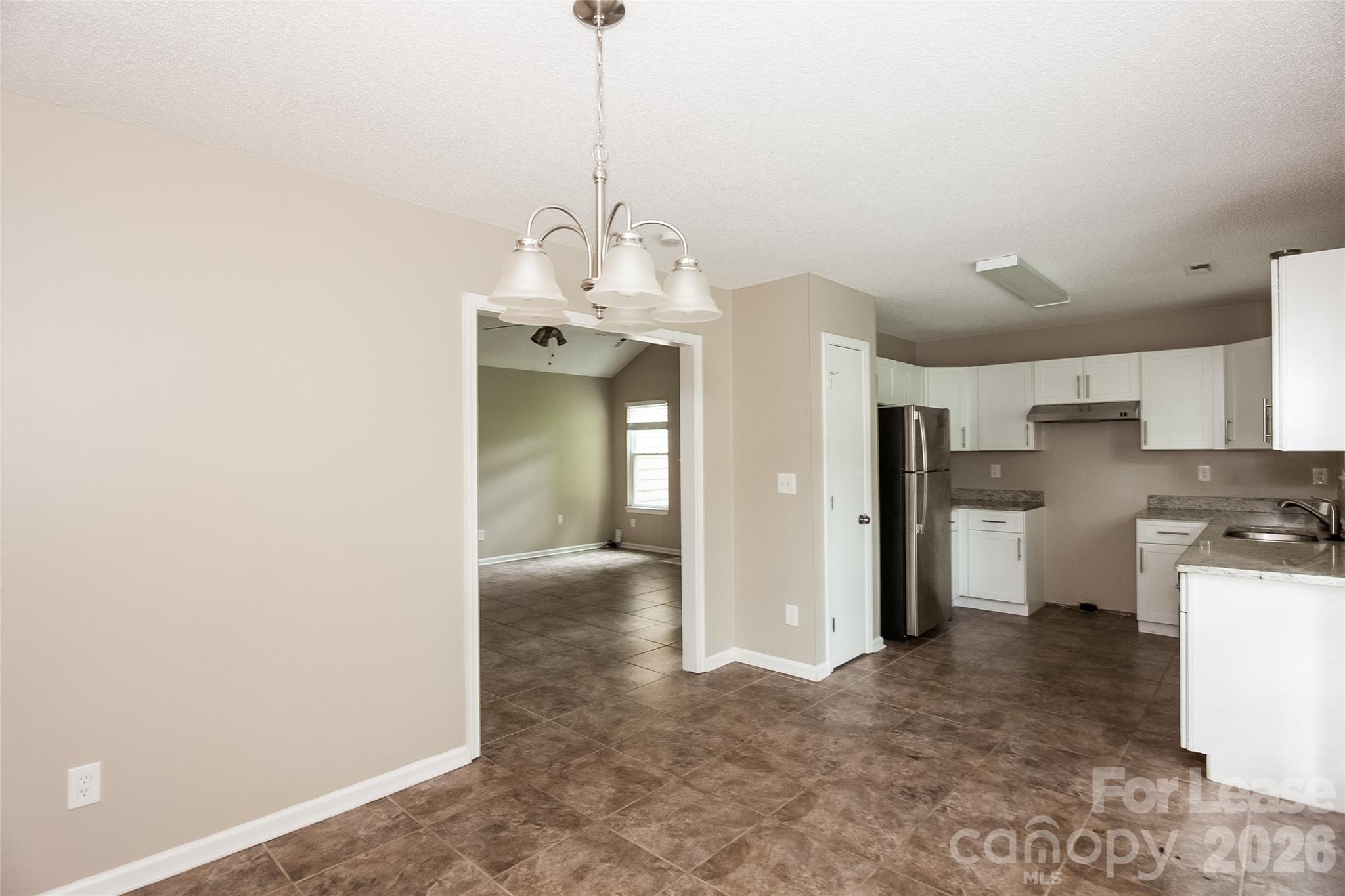 8625 Flowers Court Charlotte, NC 28215 - Photo 5 of 16 a view of a kitchen with refrigerator and cabinets