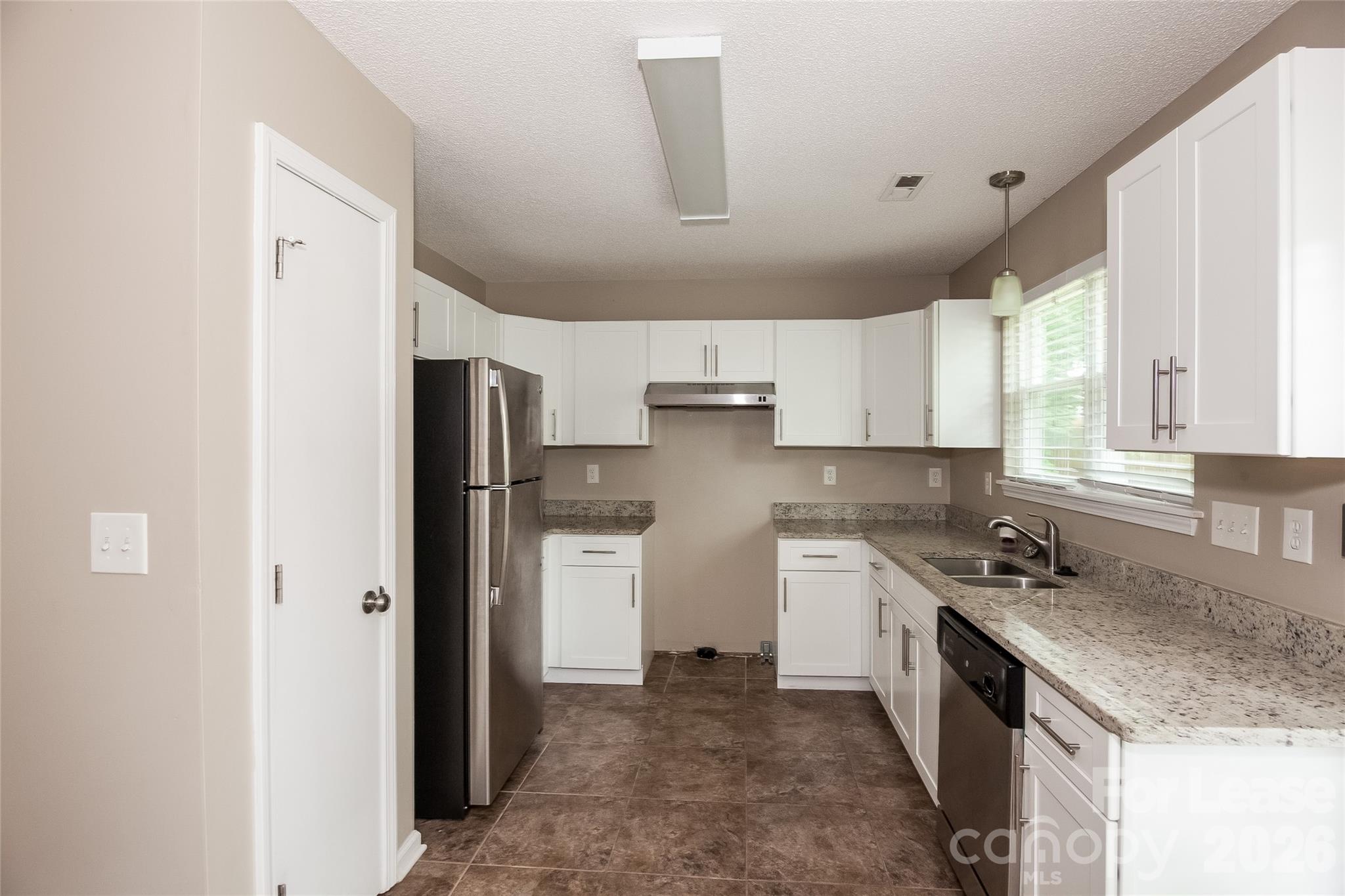 8625 Flowers Court Charlotte, NC 28215 - Photo 6 of 16 a kitchen with a sink stove and refrigerator