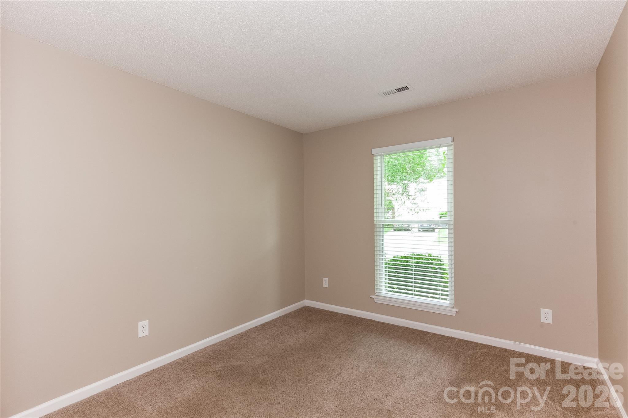 8625 Flowers Court Charlotte, NC 28215 - Photo 10 of 16 a view of an empty room with a window