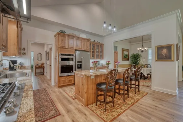 a view of a dining room with furniture a chandelier and wooden floor