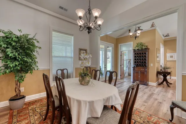 a view of a dining room with furniture and chandelier