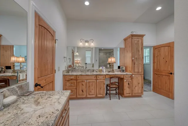 a large bathroom with a sink and a large mirror