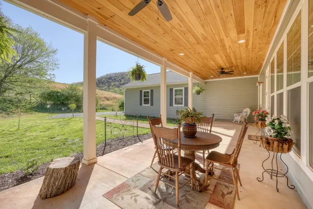 a dining room with furniture and garden view