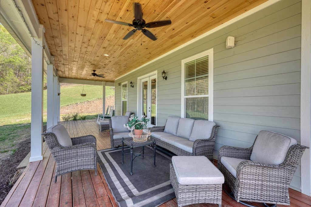 1735 Downings Creek Road Hayesville, NC 28904 - Photo 26 of 42 a balcony with wooden floor and outdoor seating