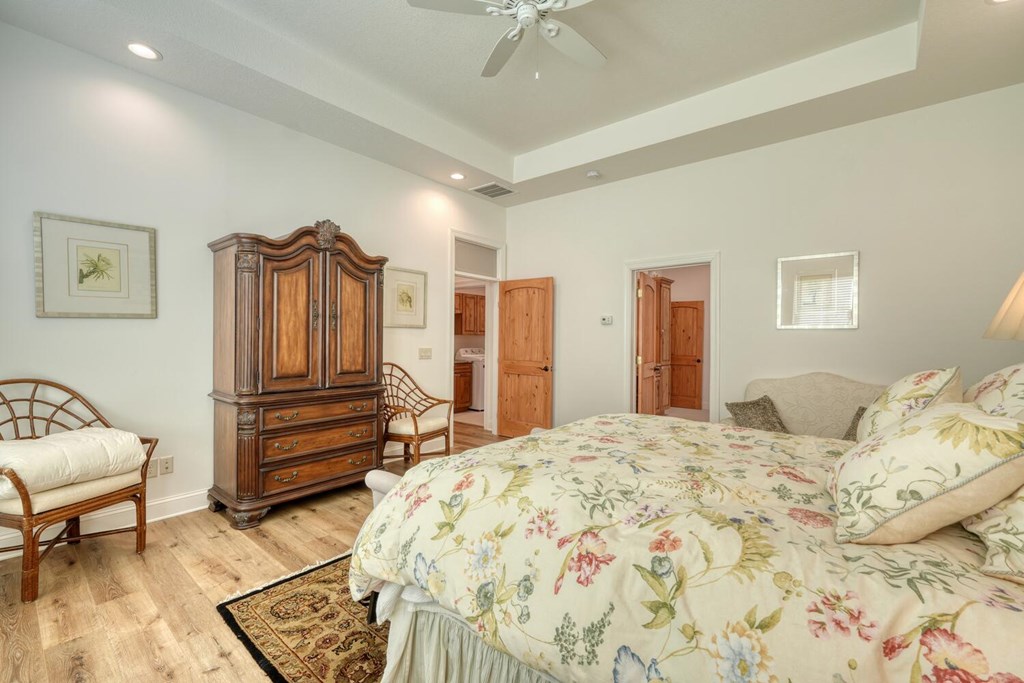 1735 Downings Creek Road Hayesville, NC 28904 - Photo 28 of 42 a bedroom with a bed and a chandelier