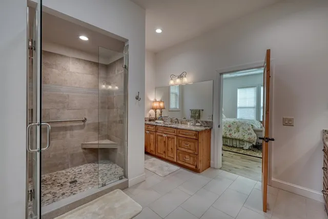 a bathroom with a granite countertop sink a toilet and shower