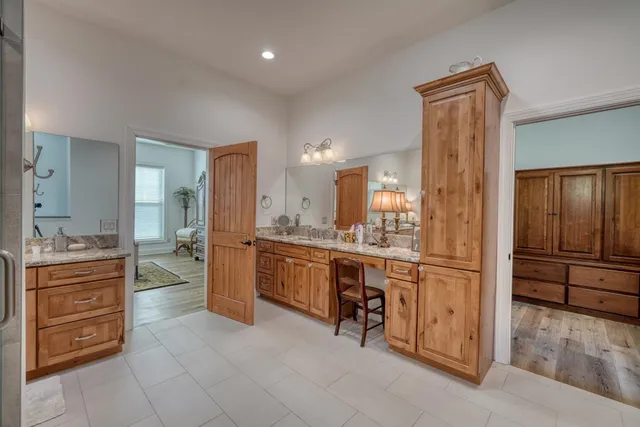 a large bathroom with a large mirror vanity and shower
