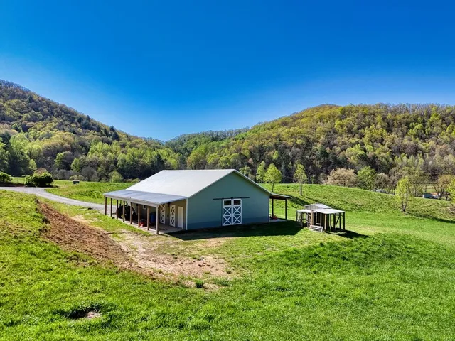 a house with green field in front of it
