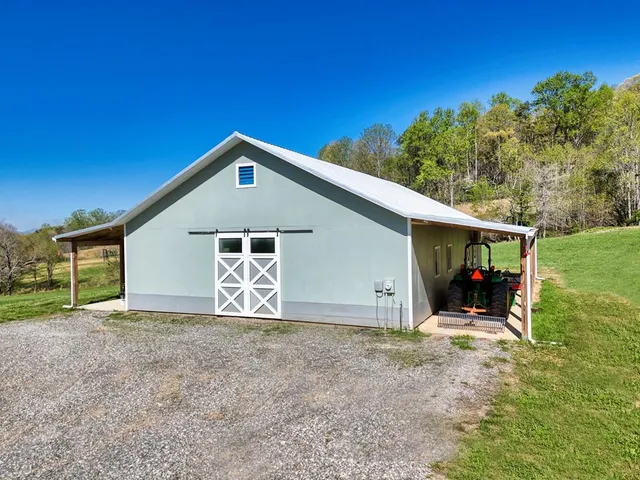 a view of a house with a yard and garage