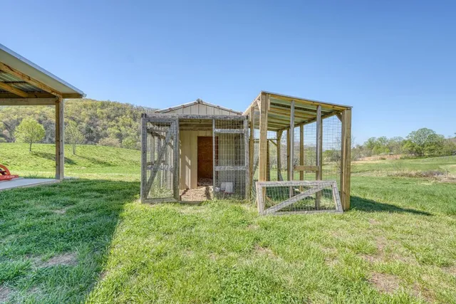 an aerial view of residential houses with outdoor space and trees