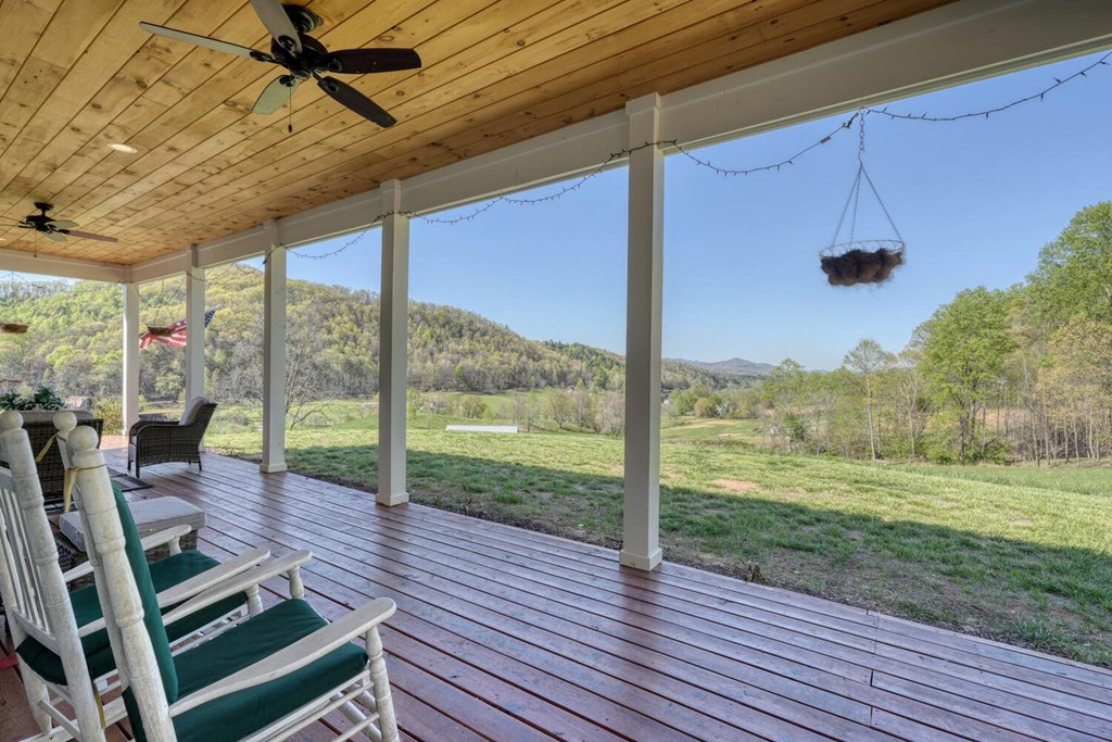 1735 Downings Creek Road Hayesville, NC 28904 - Photo 4 of 42 a view of a porch with chairs and backyard