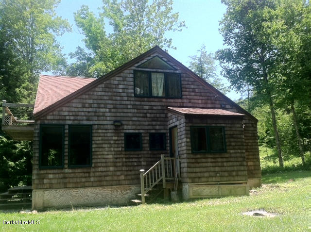 84 Windsor Pond Road Windsor, MA 01270 - Photo 32 of 46 a front view of a house with a yard