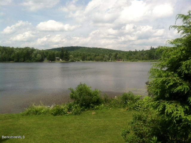84 Windsor Pond Road Windsor, MA 01270 - Photo 44 of 46 a view of a lake with houses in the back