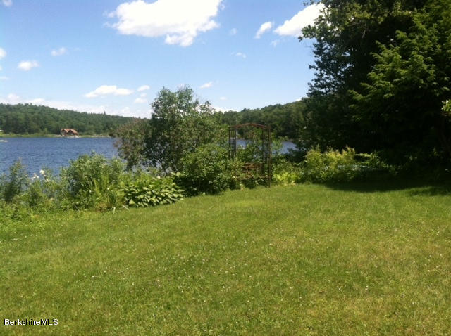 84 Windsor Pond Road Windsor, MA 01270 - Photo 46 of 46 a view of a grassy field with trees in the background