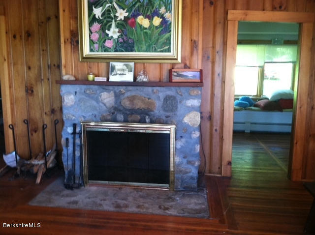 84 Windsor Pond Road Windsor, MA 01270 - Photo 10 of 46 a hallway with a fireplace and a mirror