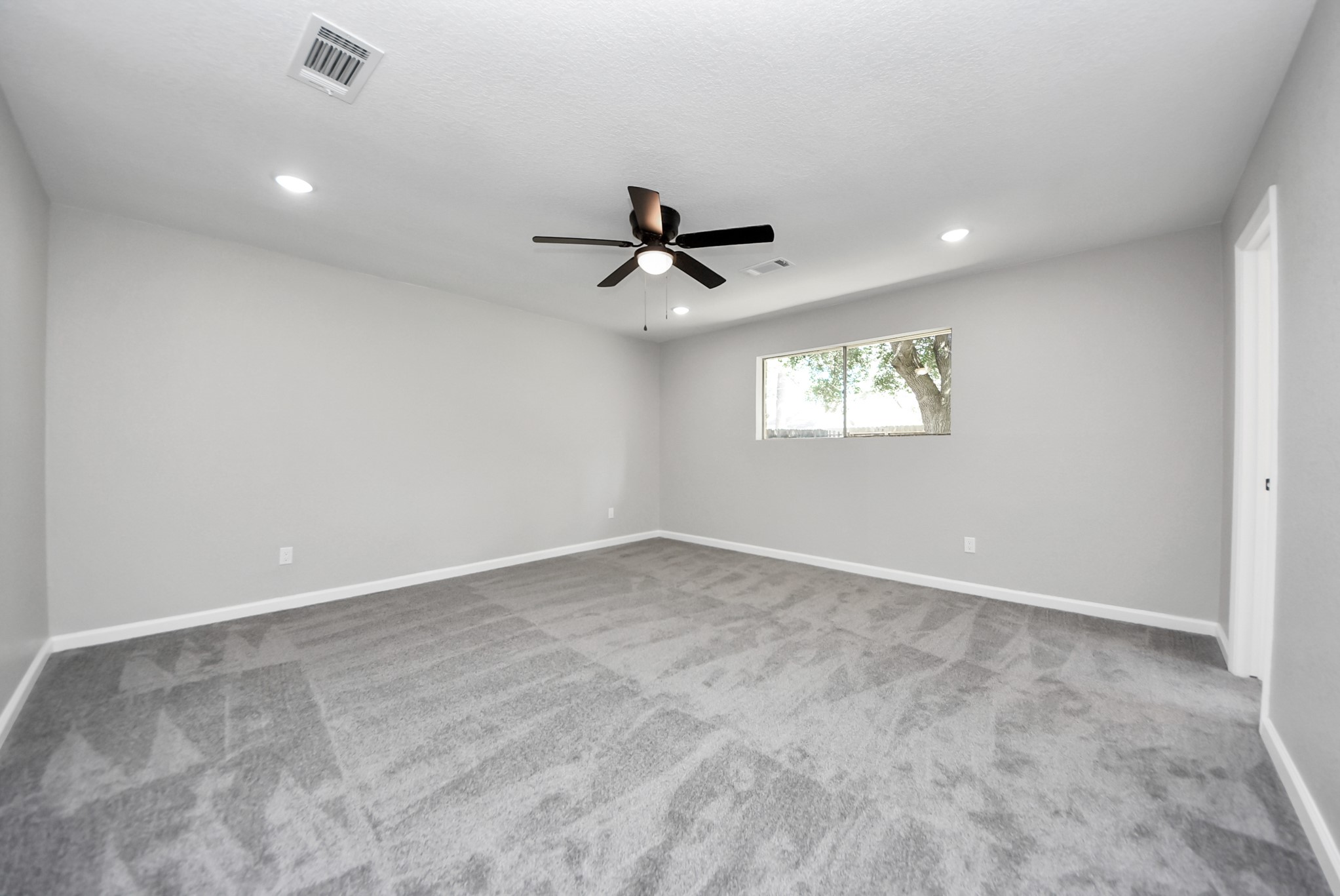 2402 Rolling Glen Drive Spring, TX 77373 - Photo 31 of 38 an empty room with windows and ceiling fan