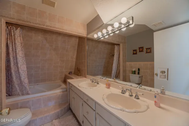a bathroom with a tub sink and mirror
