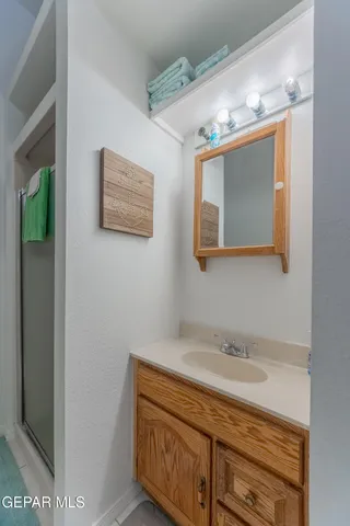 a bathroom with a sink mirror and vanity