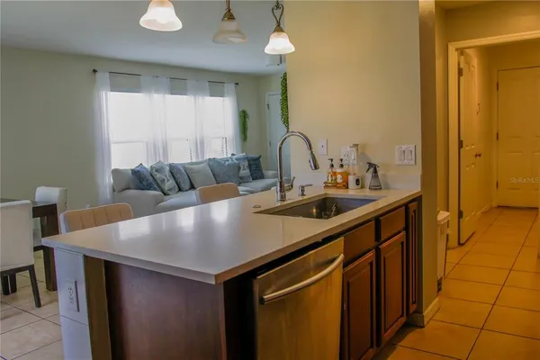 a view of kitchen island a sink and living room