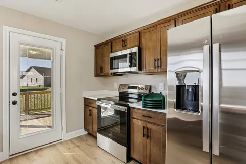 a kitchen with stainless steel appliances granite countertop a refrigerator and a stove