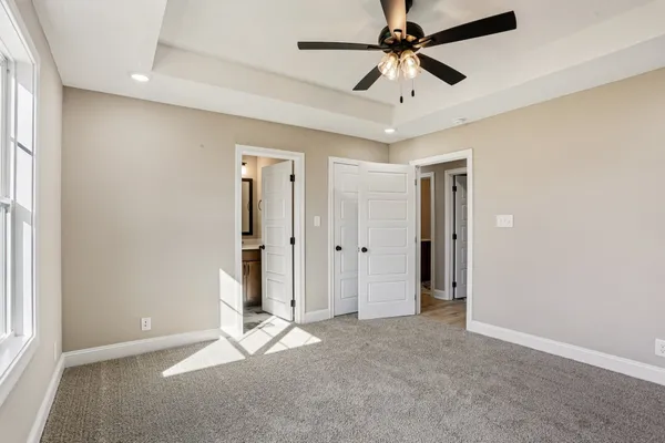 a view of a livingroom with a ceiling fan window and a ceiling fan